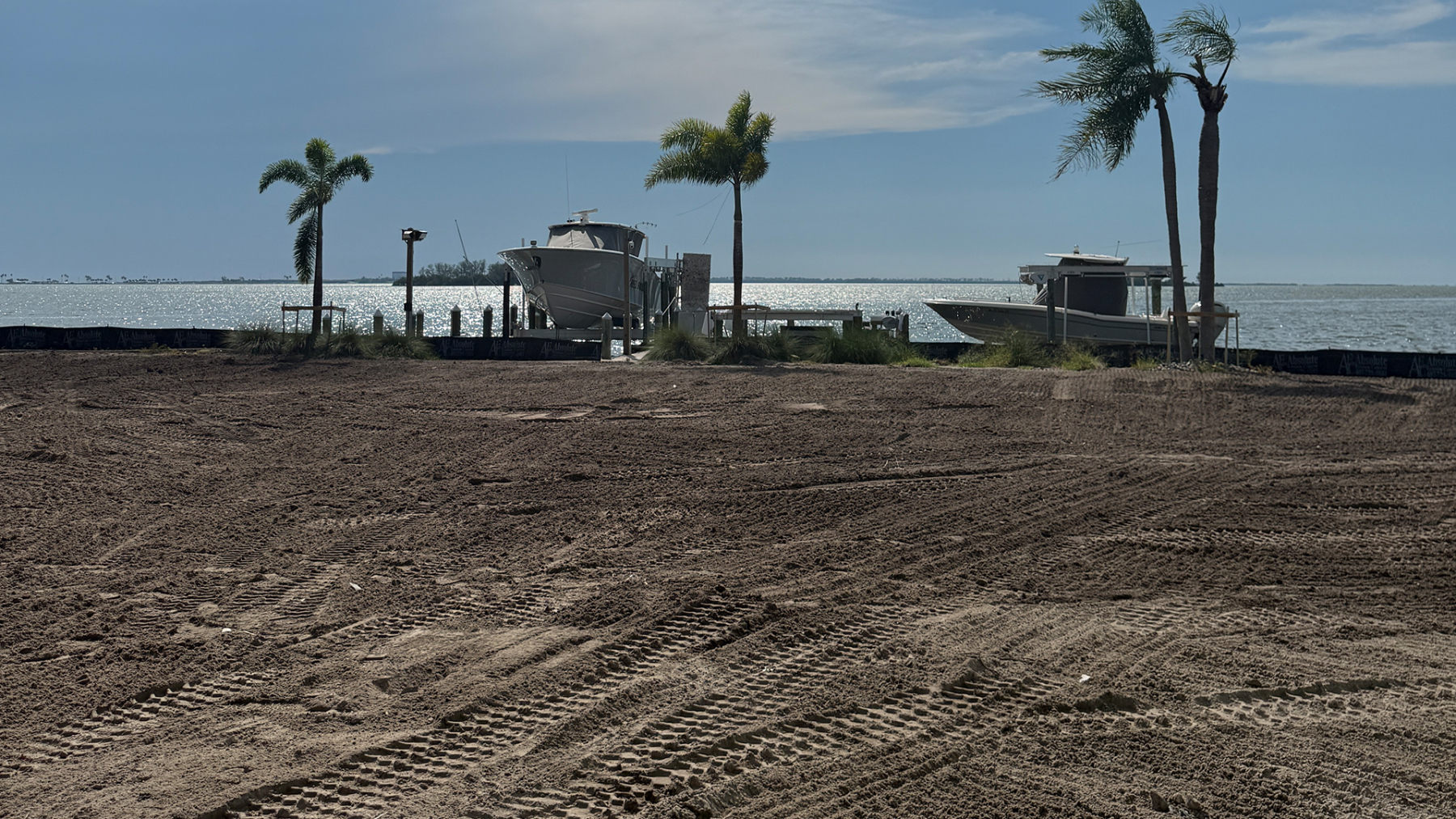The same kind of waterfront lot after clearance — graded flat and swept clean to the seawall