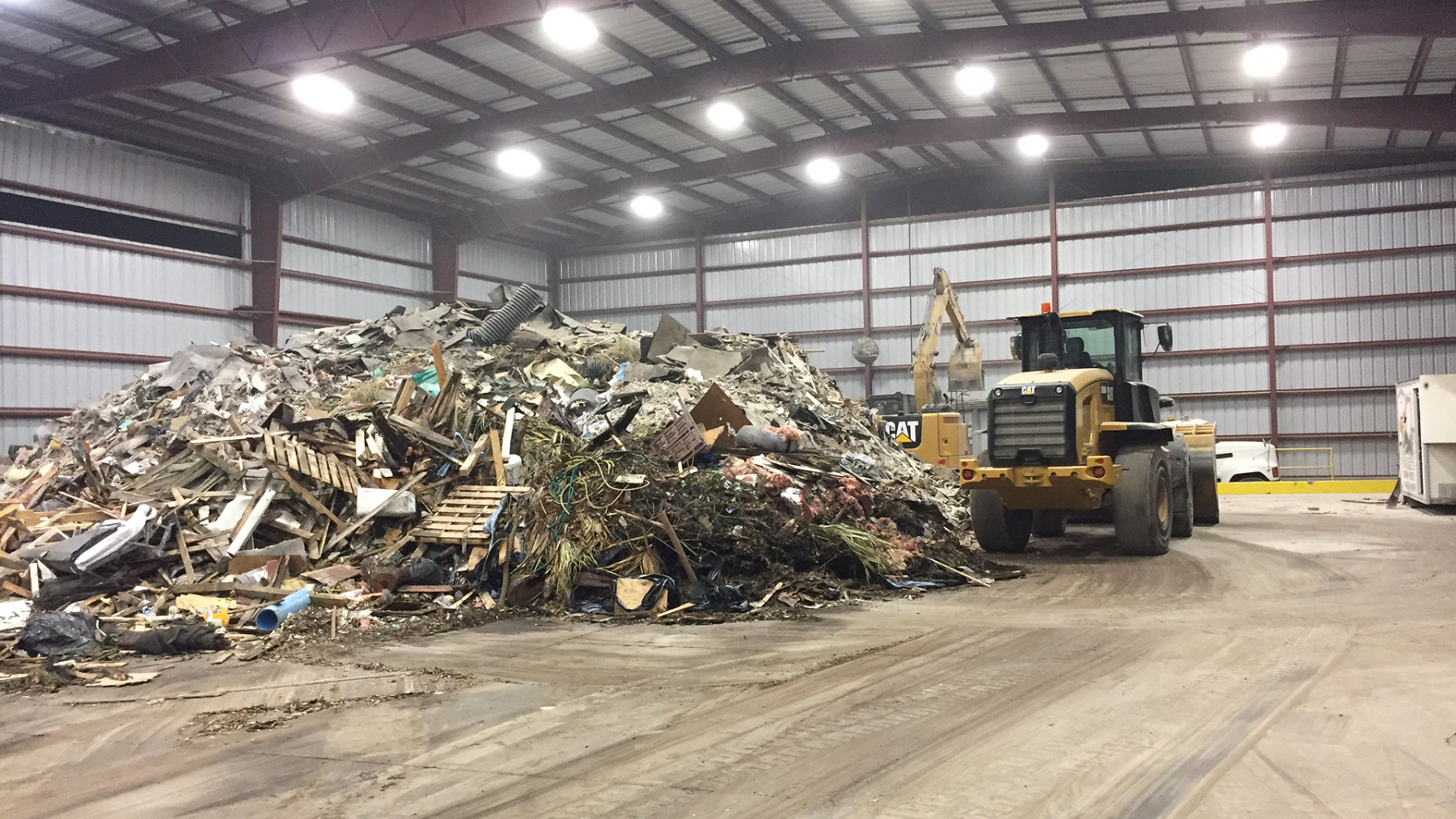 Sorted construction and demolition debris inside the covered transfer station at our Keene Rd yard