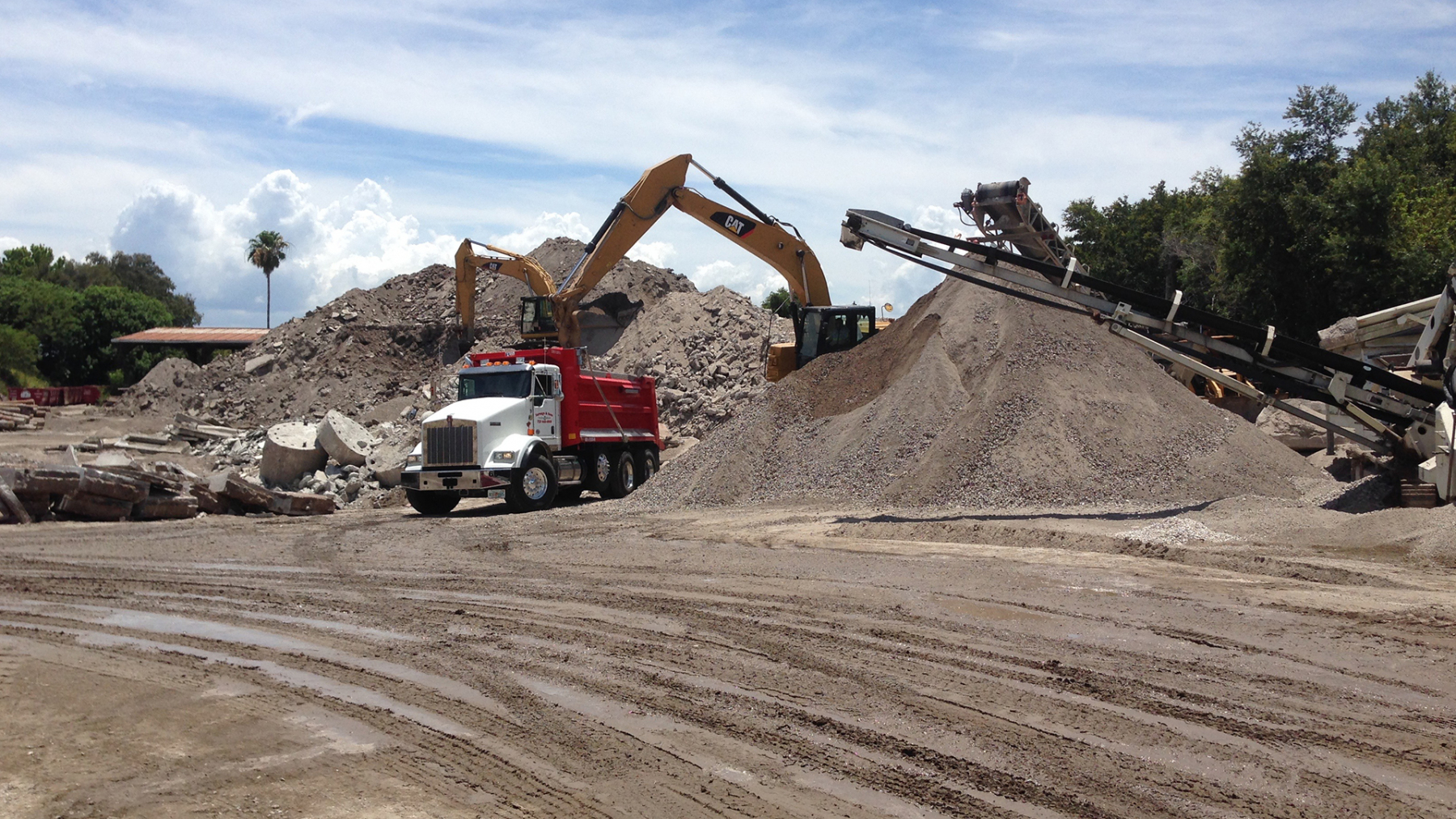 Crushing and screening plant at the yard turning demolition concrete into road base and rock stockpiles